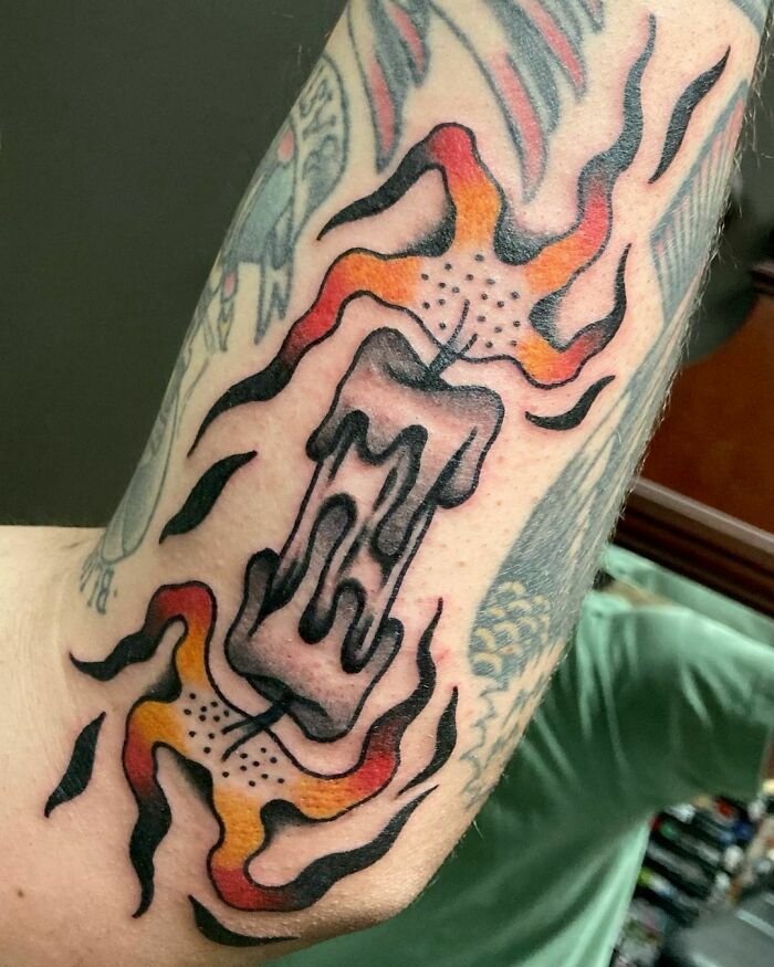 American traditional tattoo of a melting candle with flames.
