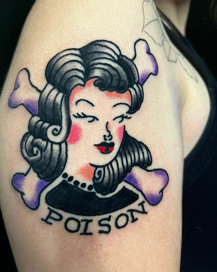 American traditional tattoo of a woman's face with bones and "poison" text on an arm.