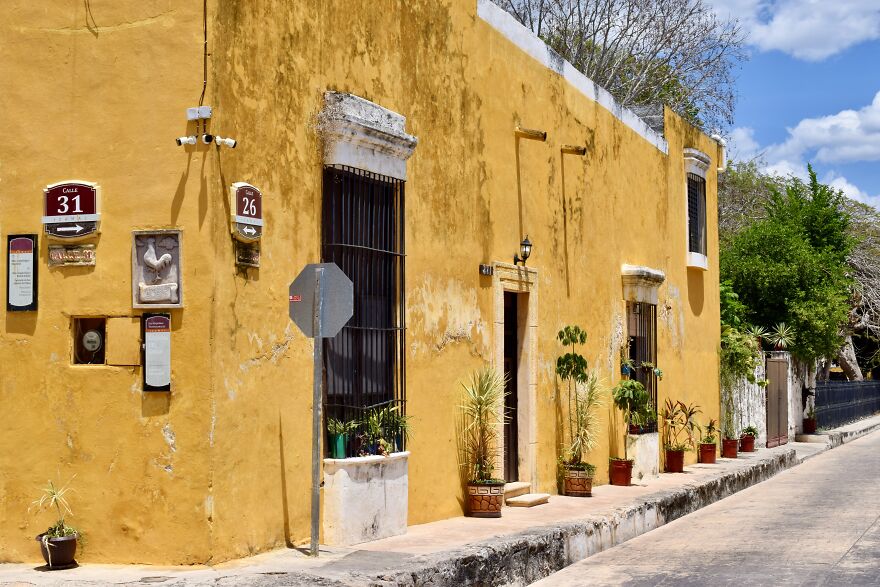 The Side Of A Building With Some Plants In Izamal, Yucatan, Mexico