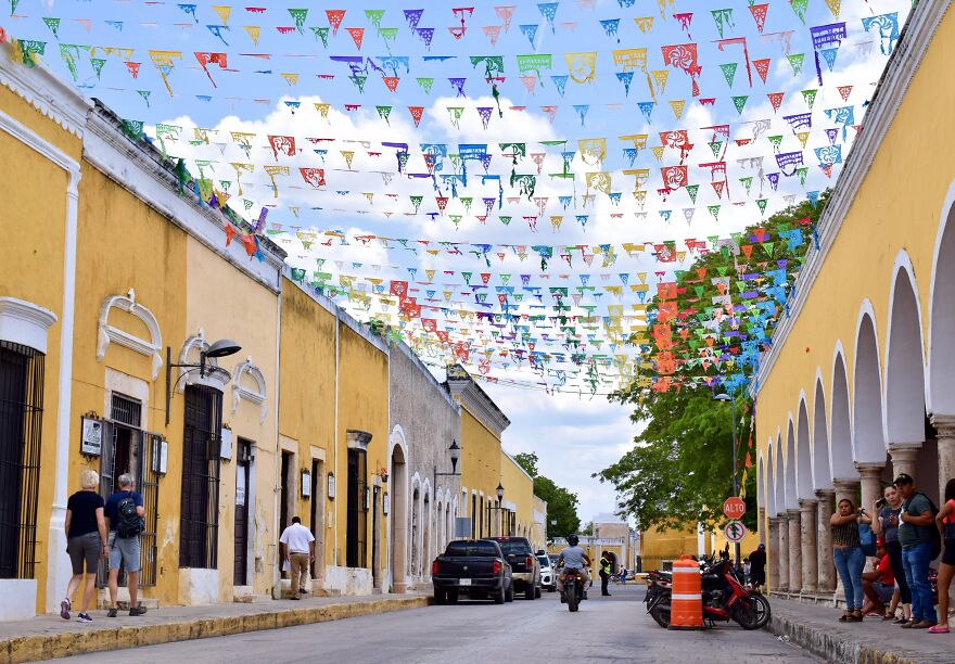A Street With Locals And Tourists In Izamal, Yucatan, Mexico