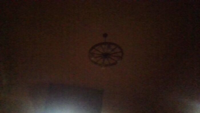 Its A Little Hard To Make Out Because The Laptop Cam But Its A Wagonwheel With Lights On It And Mason Jars Over The Lightbulbs