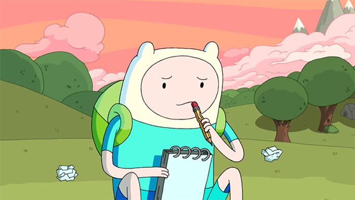 Finn the Human with pencil and notebook in his hands