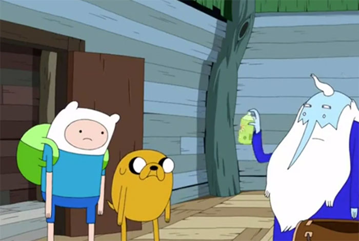 Ice King holding spray in front of Finn the Human and Jake the Dog