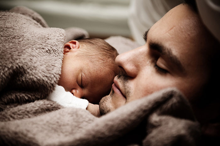 Father and baby sleeping together