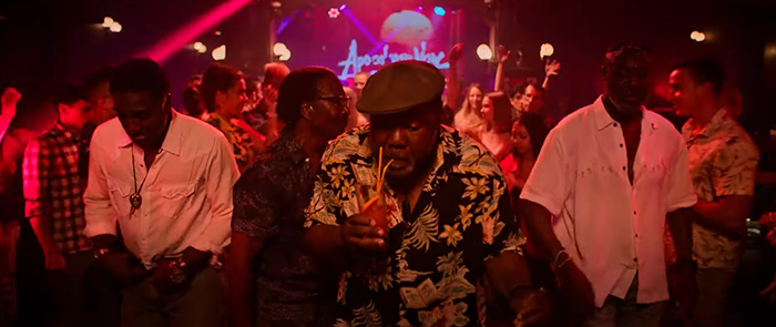 A group of black men dance in a club in Da 5 Bloods