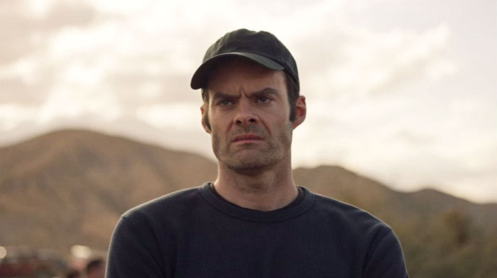 Angry man with hat on looking at someone 