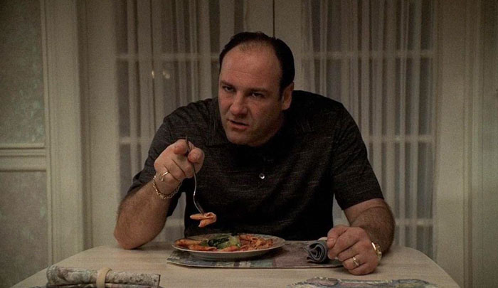 Person eating a plate of pasta