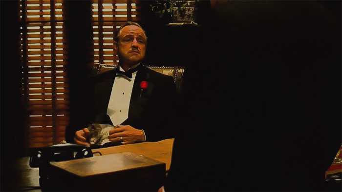 Vito Corleone wearing tuxedo, carrying a rose in the jacket pocket 