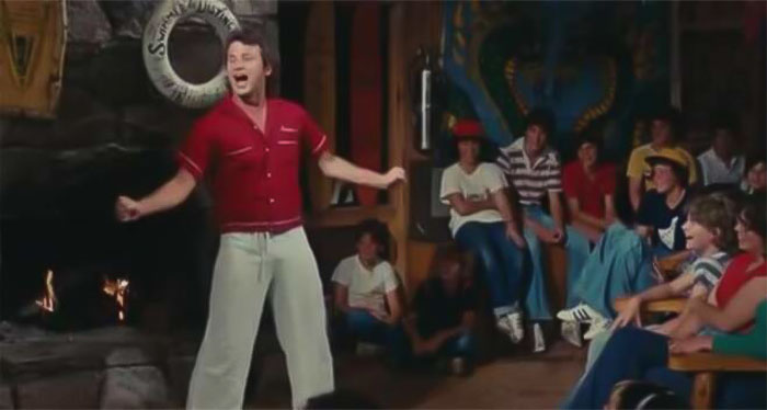 Tripper wearing red shirt and white pants 