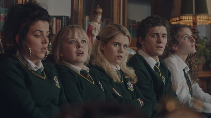 Erin Clare Michelle sitting in Derry Girls Episode 1