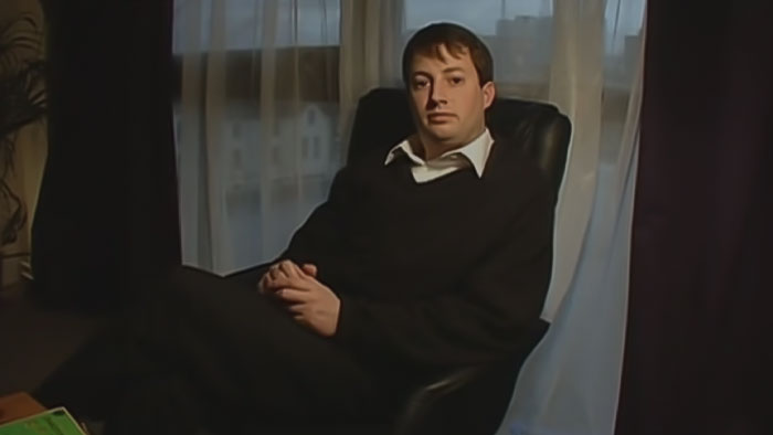 Mark sitting and looking from Peep Show Warring Factions