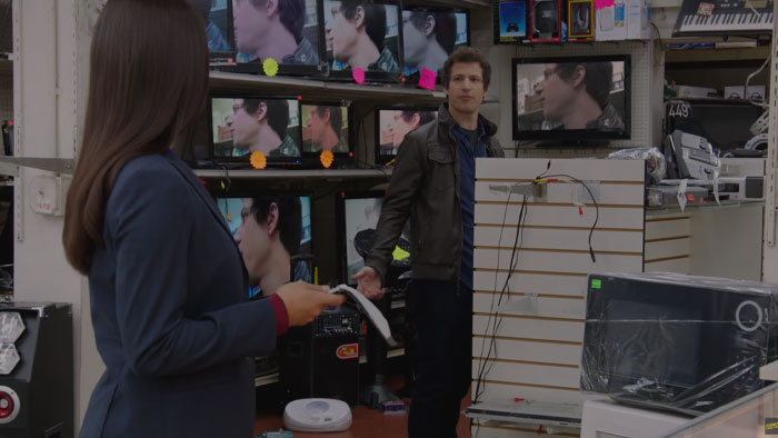 Jake talking with woman in Brooklyn Nine-Nine Pilot