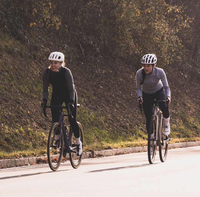 Two girls cycling on the road 