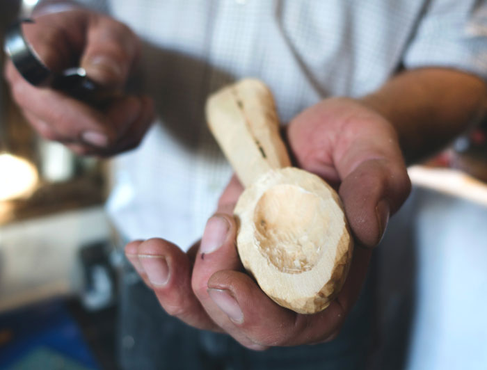 Man carving a wooden spoon 