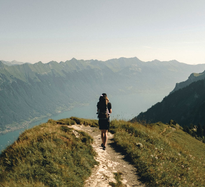 Person walking through a path in the mountains 