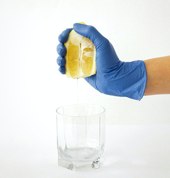Person squeezing of lemon juice