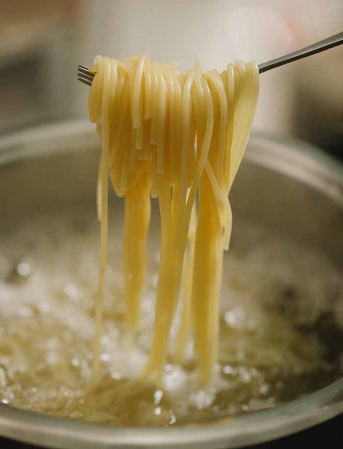 Process of cooking pasta in boiling water in pan