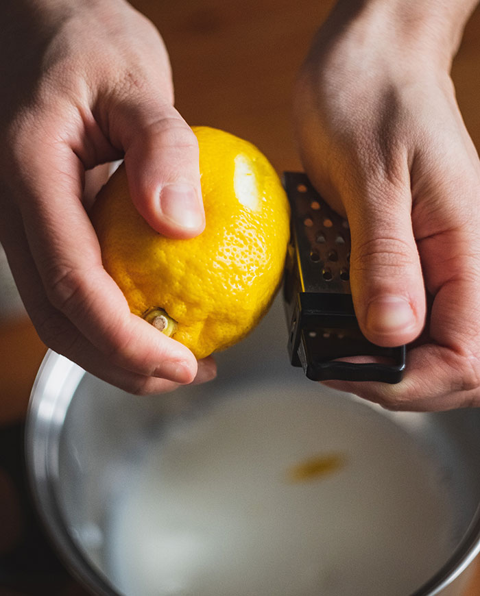 Person holding yellow citrus fruit