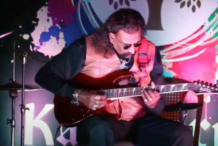 Dr. David Prabhakar Bandi playing guitar