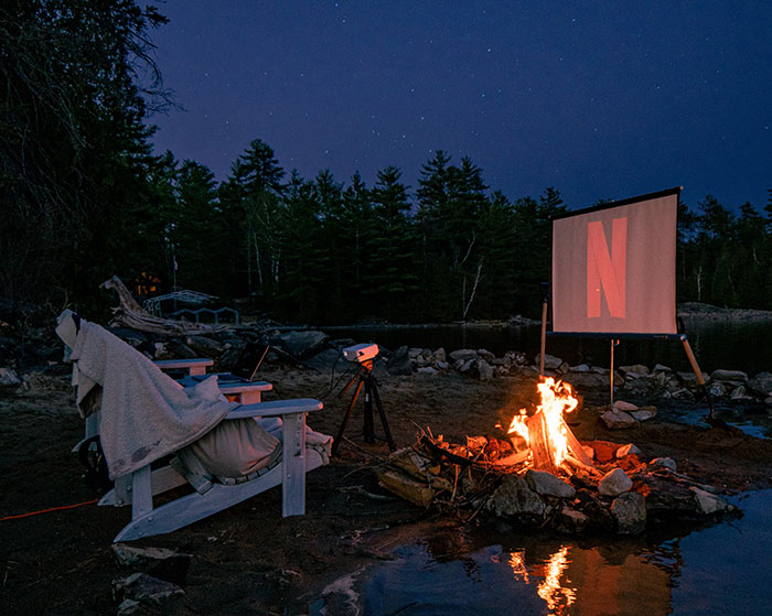 Movie night outdoors near campfire