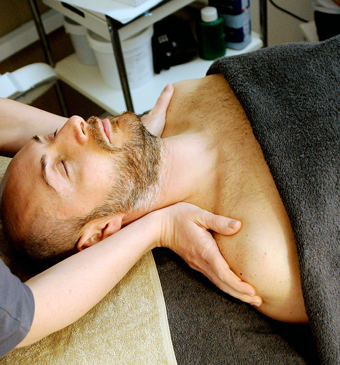 Person lying on the back and having a massage