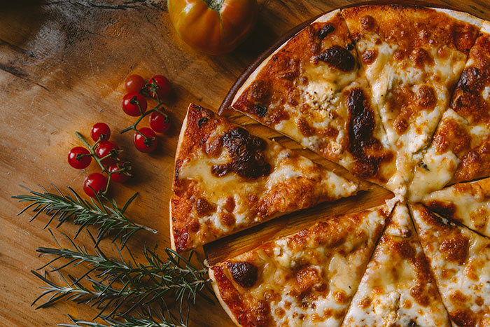 Pizza with cheese and decorations near