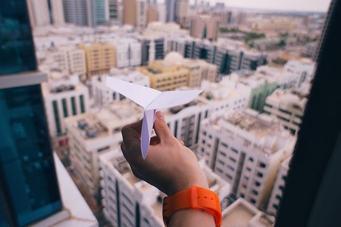 Person holding paper airplane
