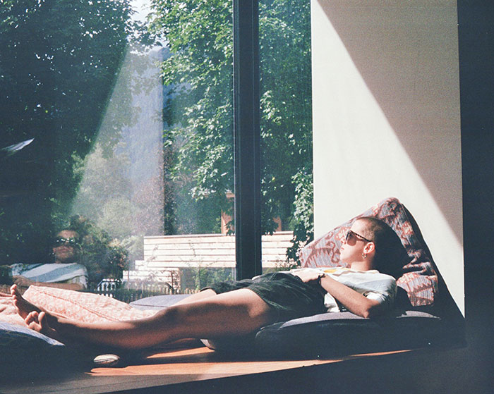 Woman lying near window