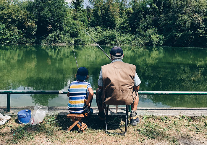 Father and son sitting and fishing