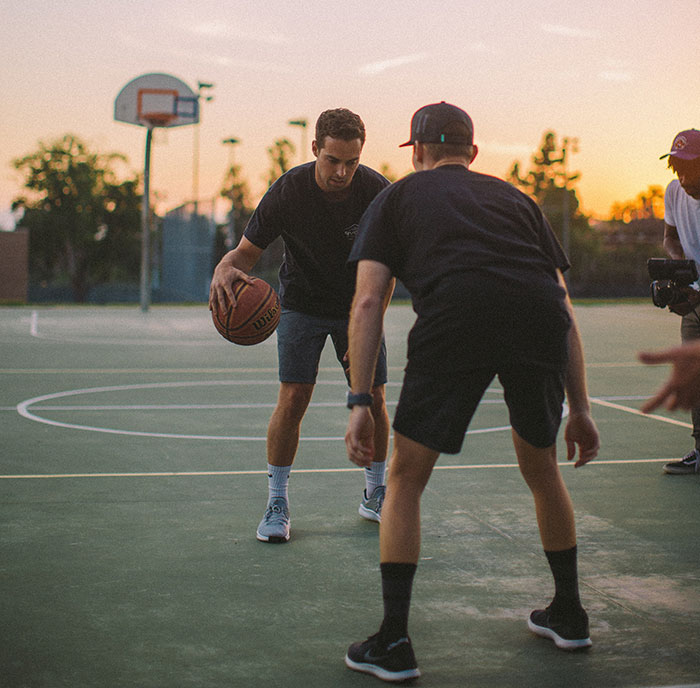 Persons playing basketball