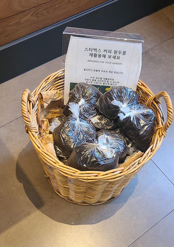Basket full of coffee grounds in plastic bags 
