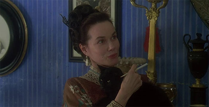 Barbara Hershey looking at someone while holding a pen 