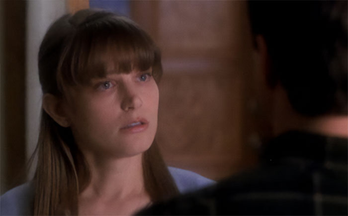 Bridget Fonda looking at someone 