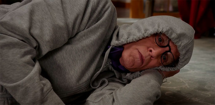 Michael wearing grey hoodie, lying on the floor