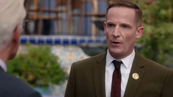 Shawn wearing a green suit