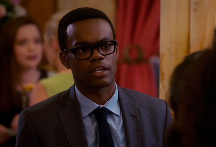 Chidi wearing black suit