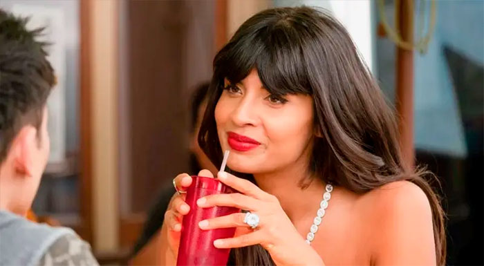 Tahani holding red cup 