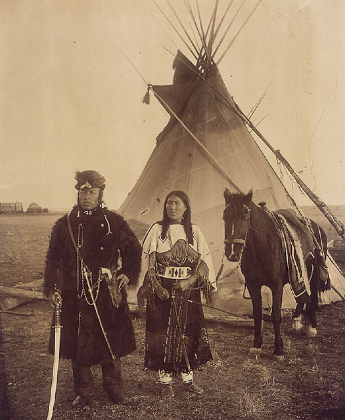 Dog Child, A North West Mounted Police Scout, And His Wife, The Only Handsome Woman, Members Of The Blackfoot Nation, Gleichen, Alberta, Ca. 1890