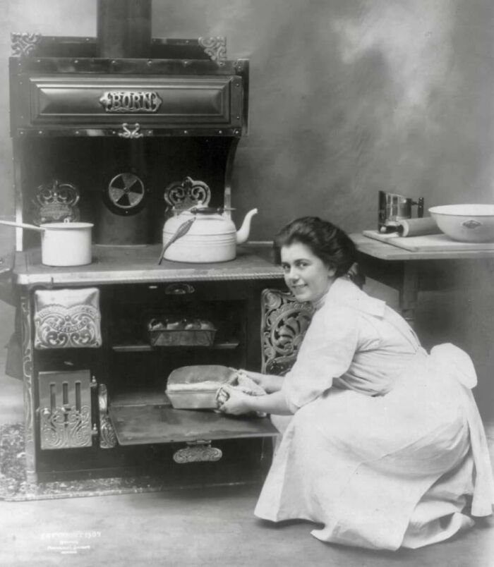 Young Woman Removing Her Loaf Of Bread From The Oven, 1909