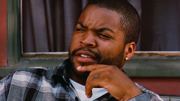 A person in a plaid shirt looking thoughtful, referencing millennial slang terms and cultural expressions.