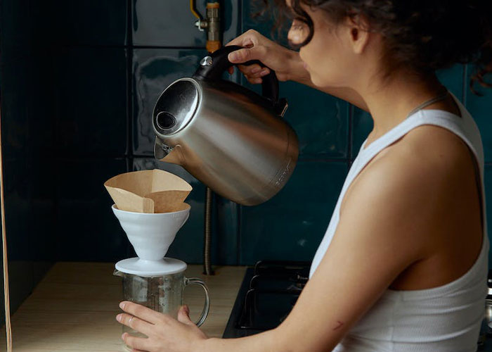 Woman making coffee with coffee filter