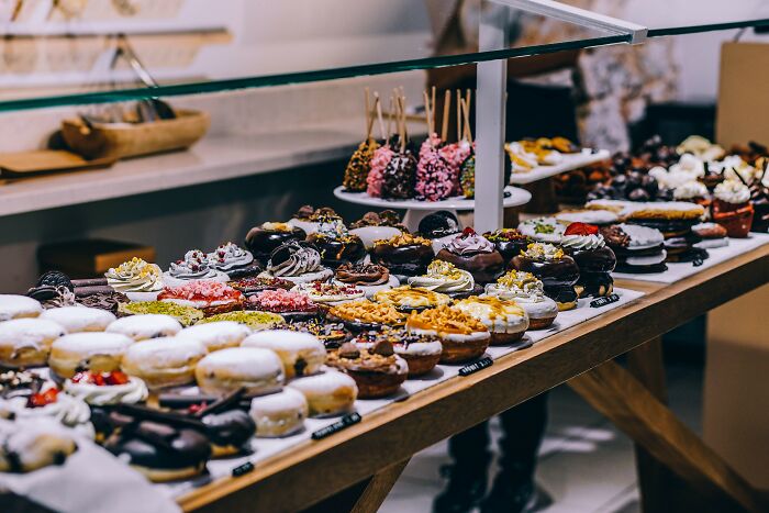 Multiple colorful pastries on the counter top 