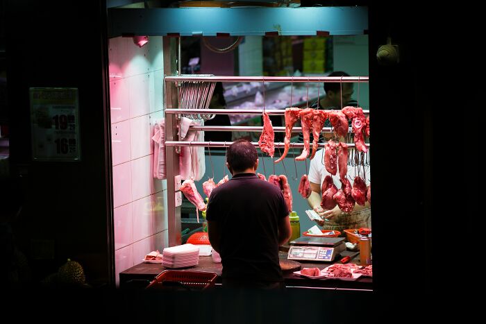 Butcher Selling Meat To A Client 