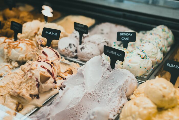 Multiple different flavors of ice cream on a counter top 