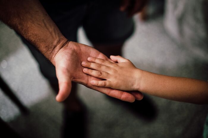 Father and kid holding hands