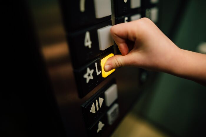 Person Clicking A Button On The Elevator 
