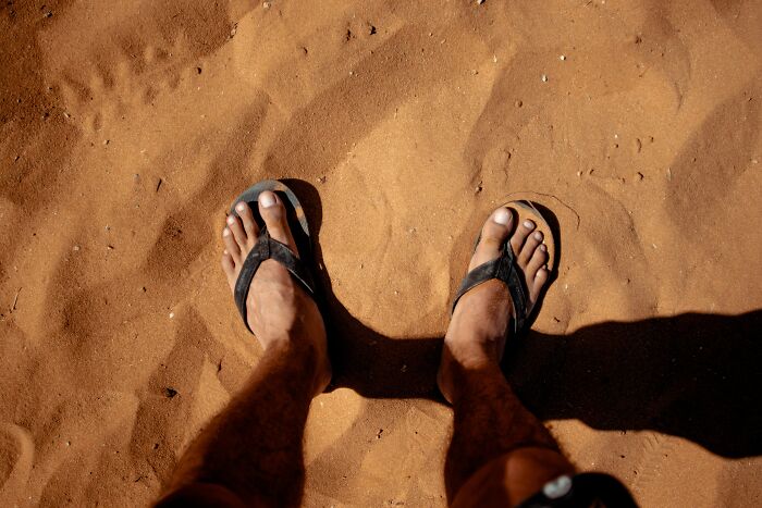 Man with flip flops in the beach 