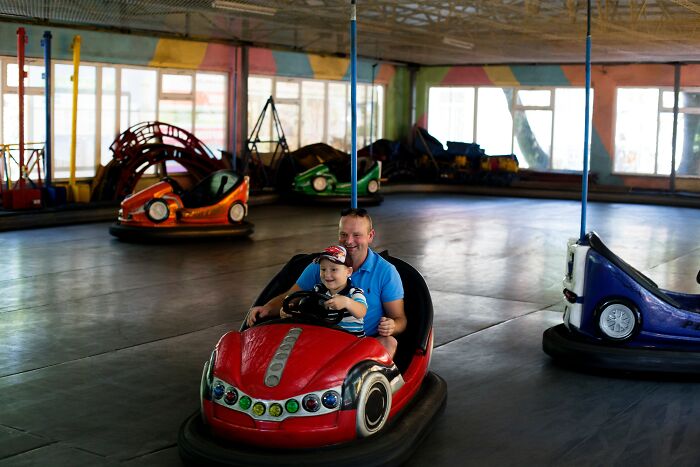 Father and son driving arcade car