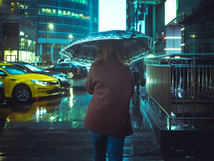 Woman walking outside with an umbrella 