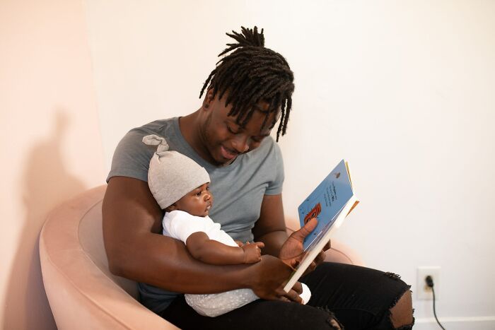 Father reading a book for a baby